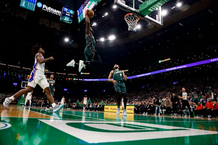 Boston Celtics guard Jaylen Brown (7) goes in for a dunk past Philadelphia 76ers guard Tyrese Maxey (0) during the third quarter at TD Garden.